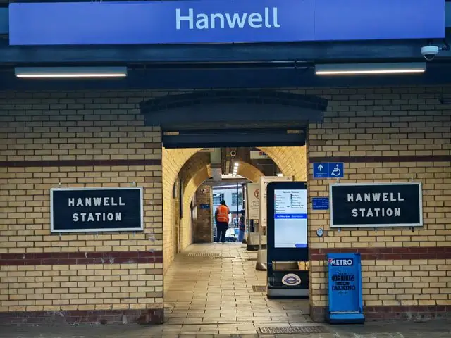View of Hanwell Station entrance in London showing signs and architecture.