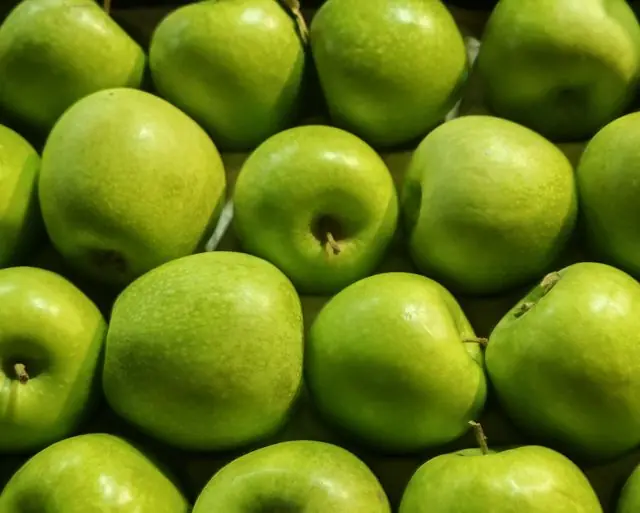 Green apples on display at a market in London.