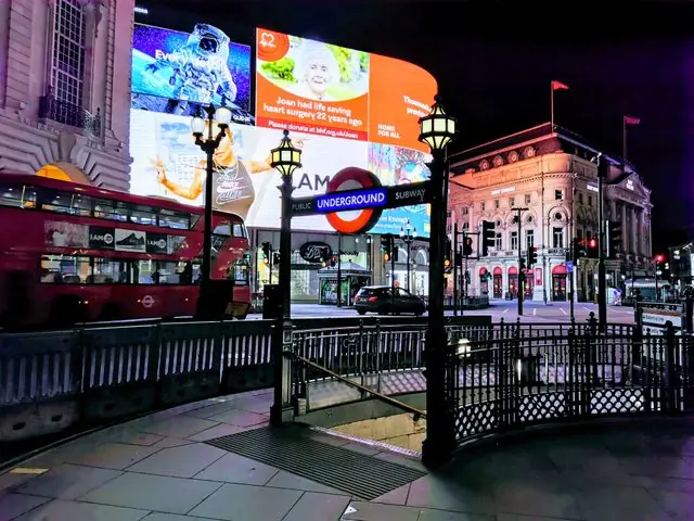 Piccadilly Circus at night, with its lights and the Underground entrance.