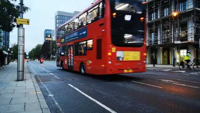 London street scene with a red double-decker bus and urban architecture.