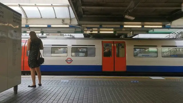 Captured at Hammersmith station, a train moves smoothly along the tracks.